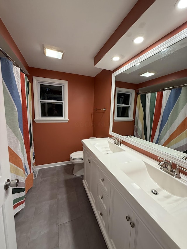 460 Blandings Ct, Worthington, OH 43085 - bathroom with double vanity, toilet, baseboards, recessed lighting, and tile patterned flooring