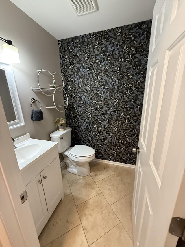 460 Blandings Ct, Worthington, OH 43085 - bathroom with wallpapered walls, vanity, toilet, tile patterned floors, and baseboards