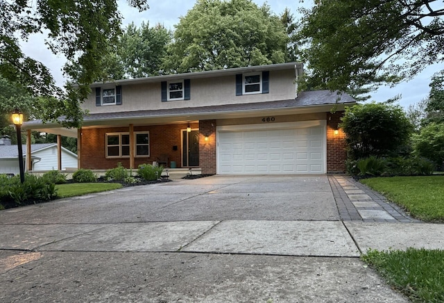 460 Blandings Ct, Worthington, OH 43085 - traditional home featuring brick siding, concrete driveway, a porch, a garage, and stucco siding