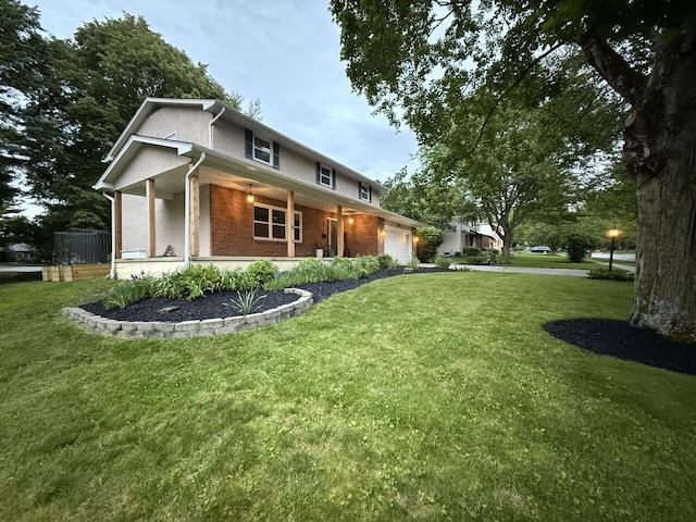 460 Blandings Ct, Worthington, OH 43085 - view of front of property featuring an attached garage, a porch, a front yard, and brick siding