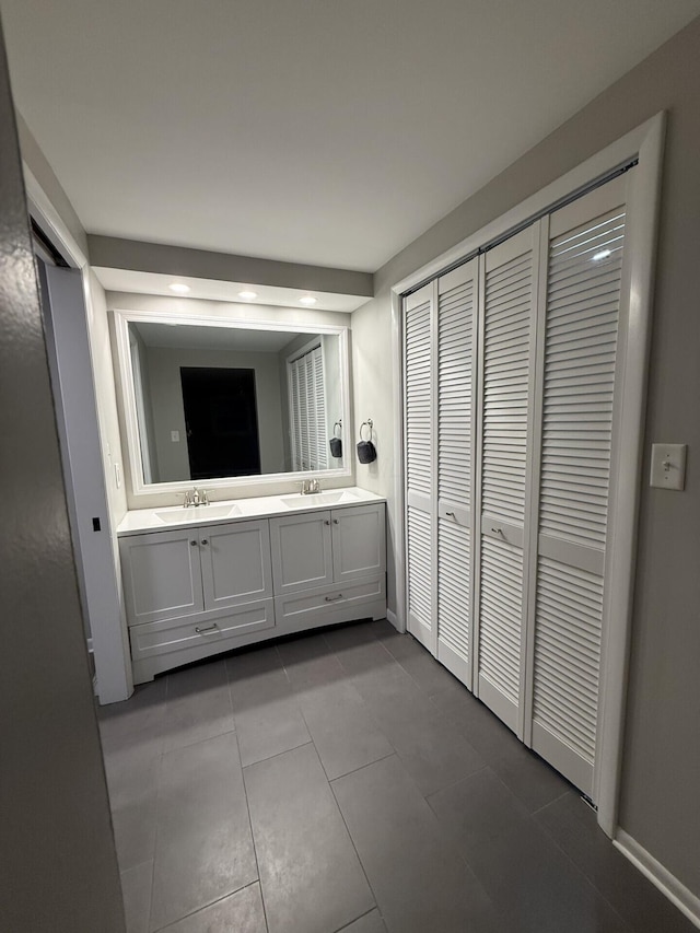 460 Blandings Ct, Worthington, OH 43085 - bathroom with double vanity, a closet, tile patterned floors, baseboards, and recessed lighting