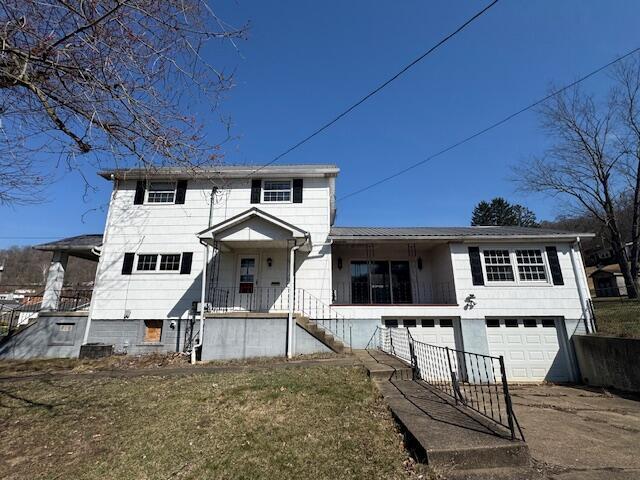 68511 Liston Ave, Bridgeport, OH 43912 - view of front of home featuring an attached garage, driveway, and a porch