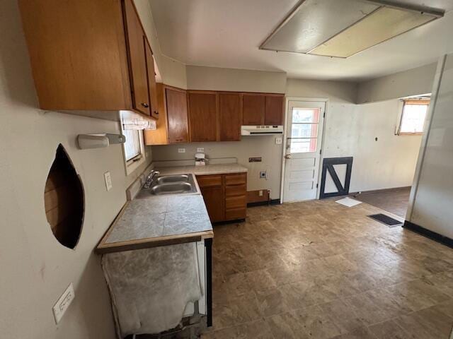 68511 Liston Ave, Bridgeport, OH 43912 - kitchen featuring brown cabinetry, a sink, and under cabinet range hood