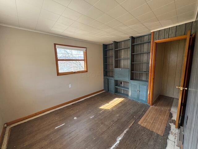 68511 Liston Ave, Bridgeport, OH 43912 - unfurnished living room with wood finished floors, built in shelves, baseboards, and ornamental molding