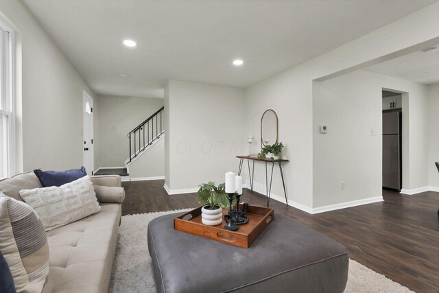 1465 Zenner Dr, Columbus, OH 43207 - living room featuring wood finished floors, stairs, baseboards, and recessed lighting