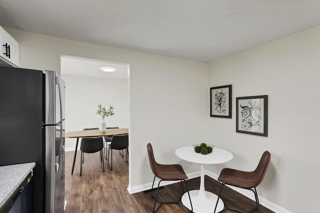 1465 Zenner Dr, Columbus, OH 43207 - dining area featuring dark wood-style flooring and baseboards