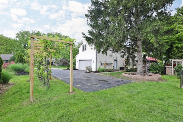 4359 Shire Cove Rd, Hilliard, OH 43026 - view of green lawn featuring an attached garage and driveway