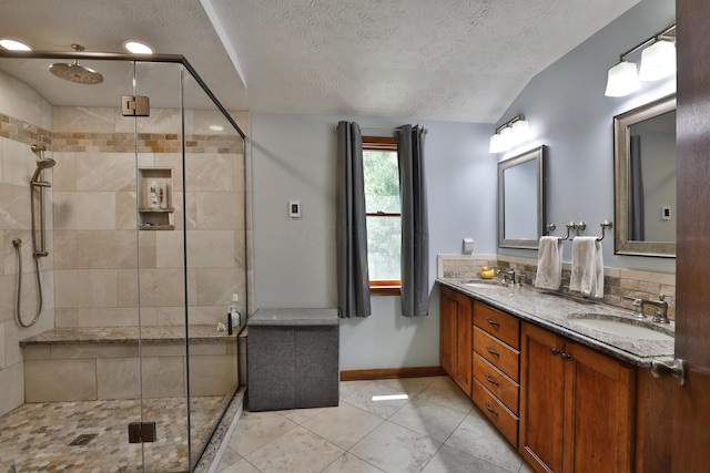 4359 Shire Cove Rd, Hilliard, OH 43026 - full bathroom featuring a shower stall, double vanity, a textured ceiling, tile patterned flooring, and baseboards