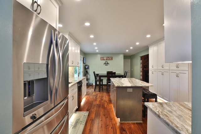 4359 Shire Cove Rd, Hilliard, OH 43026 - kitchen featuring stainless steel refrigerator with ice dispenser, recessed lighting, white cabinets, a center island, and light stone counters