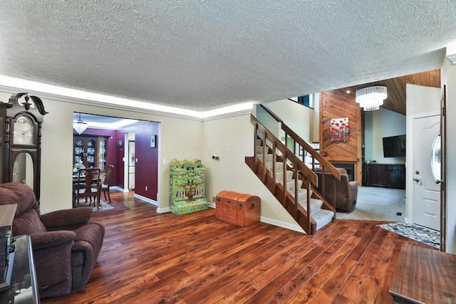 4359 Shire Cove Rd, Hilliard, OH 43026 - foyer with a chandelier, a textured ceiling, stairway, wood finished floors, and baseboards