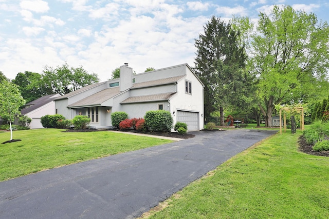 4359 Shire Cove Rd, Hilliard, OH 43026 - view of front of home featuring a chimney, a garage, driveway, and a front yard
