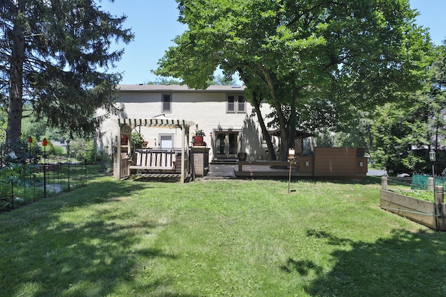 4359 Shire Cove Rd, Hilliard, OH 43026 - back of property with a wooden deck, a vegetable garden, stucco siding, and a pergola