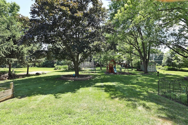 4359 Shire Cove Rd, Hilliard, OH 43026 - view of green lawn with a shed, a playground, and a trampoline
