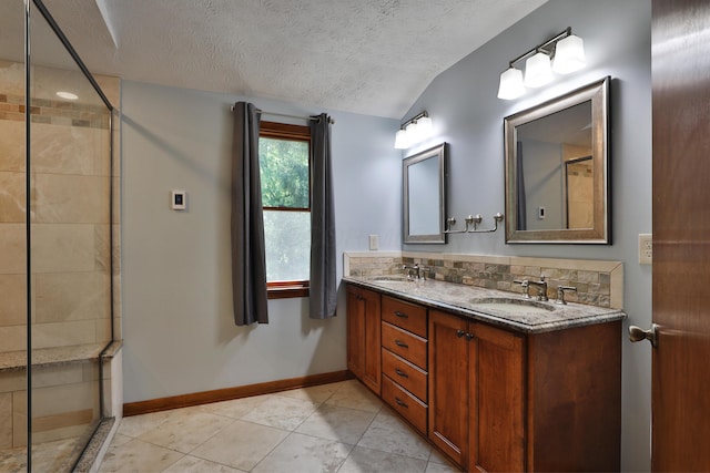4359 Shire Cove Rd, Hilliard, OH 43026 - full bath with a textured ceiling, double vanity, vaulted ceiling, tiled shower, and tile patterned flooring
