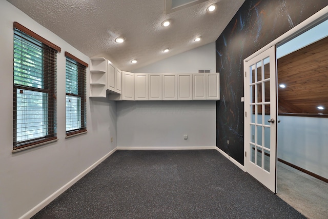 4359 Shire Cove Rd, Hilliard, OH 43026 - unfurnished room with french doors, a textured ceiling, dark carpet, vaulted ceiling, and recessed lighting