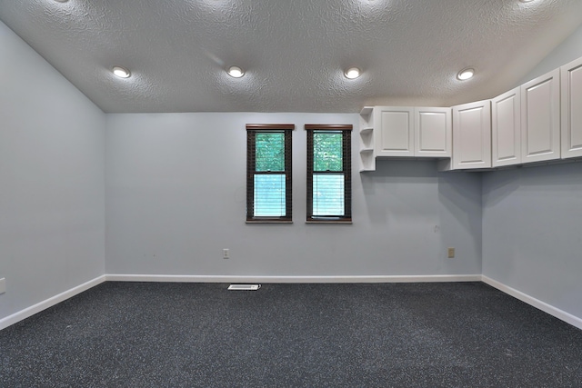 4359 Shire Cove Rd, Hilliard, OH 43026 - spare room with a textured ceiling and dark colored carpet
