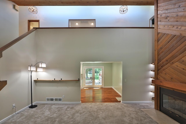 4359 Shire Cove Rd, Hilliard, OH 43026 - unfurnished living room featuring carpet floors, a fireplace with flush hearth, and a towering ceiling