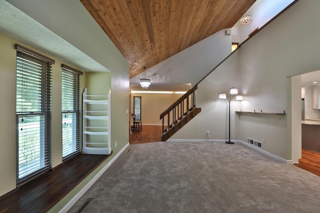 4359 Shire Cove Rd, Hilliard, OH 43026 - unfurnished living room featuring carpet, stairs, wooden ceiling, high vaulted ceiling, and wood finished floors