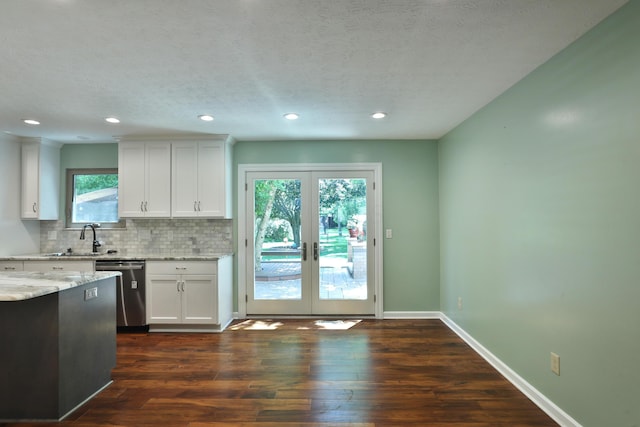 4359 Shire Cove Rd, Hilliard, OH 43026 - kitchen with dishwasher, decorative backsplash, white cabinetry, dark wood-style flooring, and a textured ceiling