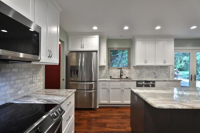 4359 Shire Cove Rd, Hilliard, OH 43026 - kitchen with stainless steel appliances, decorative backsplash, dark wood-type flooring, white cabinetry, and recessed lighting