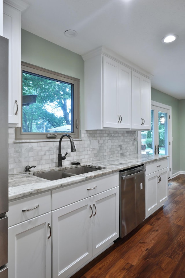 4359 Shire Cove Rd, Hilliard, OH 43026 - kitchen with stainless steel dishwasher, tasteful backsplash, white cabinets, dark wood finished floors, and recessed lighting