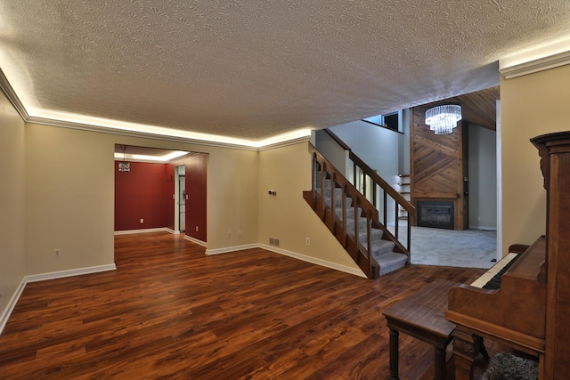 4359 Shire Cove Rd, Hilliard, OH 43026 - below grade area featuring a textured ceiling, stairway, wood finished floors, a fireplace, and a chandelier