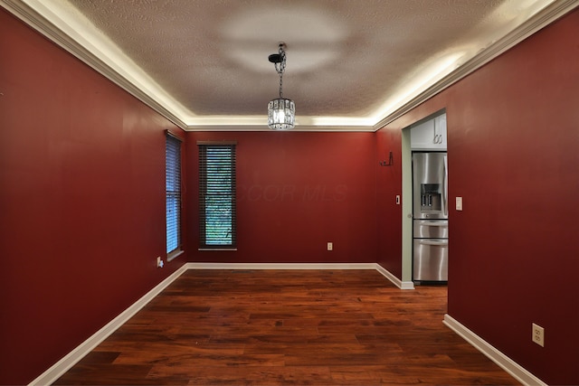 4359 Shire Cove Rd, Hilliard, OH 43026 - unfurnished dining area with a textured ceiling, dark wood finished floors, and a tray ceiling