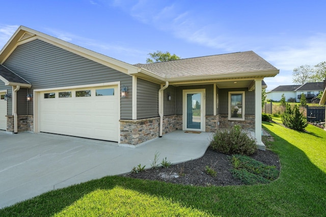 107 Willows End, Bellefontaine, OH 43311 - view of front of property with stone siding, a garage, a front yard, and concrete driveway