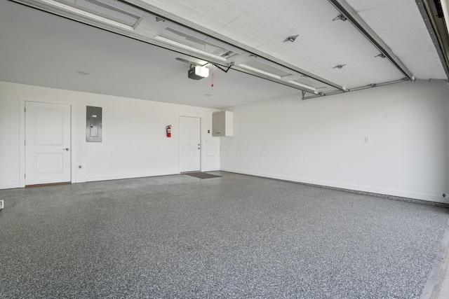107 Willows End, Bellefontaine, OH 43311 - garage featuring a garage door opener, electric panel, and baseboards