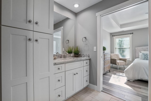 107 Willows End, Bellefontaine, OH 43311 - ensuite bathroom featuring vanity, wood finished floors, and baseboards
