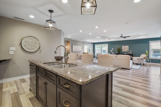 107 Willows End, Bellefontaine, OH 43311 - kitchen featuring a sink, stainless steel dishwasher, light wood finished floors, recessed lighting, and hanging light fixtures