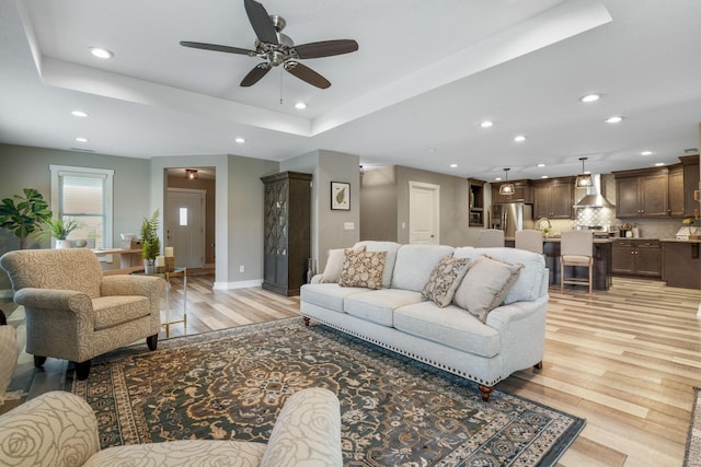 107 Willows End, Bellefontaine, OH 43311 - living room with a ceiling fan, light wood-style flooring, recessed lighting, baseboards, and a tray ceiling