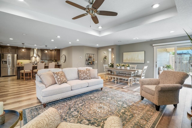 107 Willows End, Bellefontaine, OH 43311 - living area with light wood-style flooring, recessed lighting, a ceiling fan, and a tray ceiling