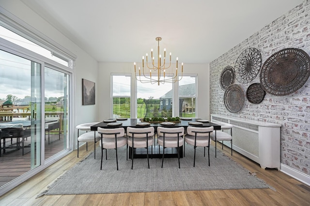 2733 Sycamore Trce, Hilliard, OH 43026 - dining room with a chandelier, wood finished floors, and baseboards