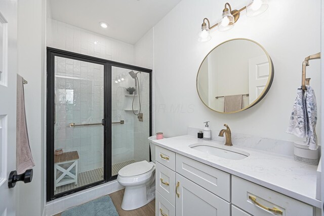2733 Sycamore Trce, Hilliard, OH 43026 - bathroom featuring vanity, toilet, a shower stall, and wood finished floors