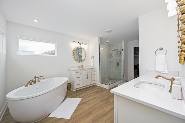 2733 Sycamore Trce, Hilliard, OH 43026 - full bath with two vanities, a stall shower, a soaking tub, and wood finished floors