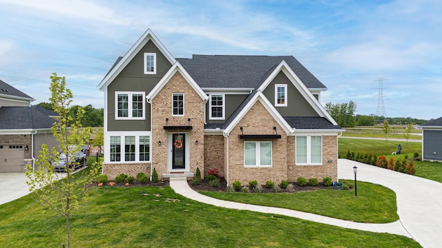 2733 Sycamore Trce, Hilliard, OH 43026 - view of front of home with concrete driveway, a front yard, brick siding, and a shingled roof