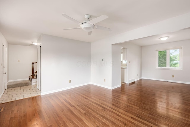 1609 Slade Ave, Columbus, OH 43235 - empty room featuring wood finished floors, stairway, a ceiling fan, and baseboards