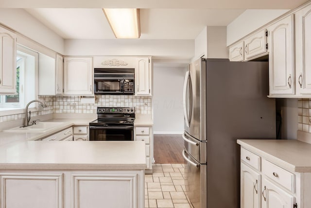 1609 Slade Ave, Columbus, OH 43235 - kitchen with black appliances, a sink, a peninsula, and backsplash