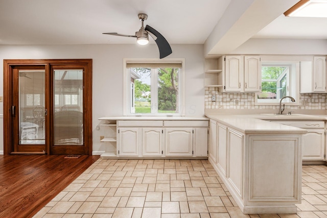 1609 Slade Ave, Columbus, OH 43235 - kitchen featuring open shelves, a sink, a ceiling fan, light countertops, and decorative backsplash