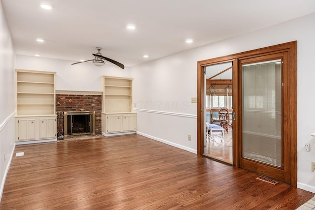 1609 Slade Ave, Columbus, OH 43235 - unfurnished living room featuring a ceiling fan, wood finished floors, baseboards, recessed lighting, and a brick fireplace