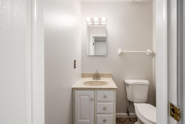 1609 Slade Ave, Columbus, OH 43235 - half bathroom with toilet, vanity, baseboards, and tile patterned floors