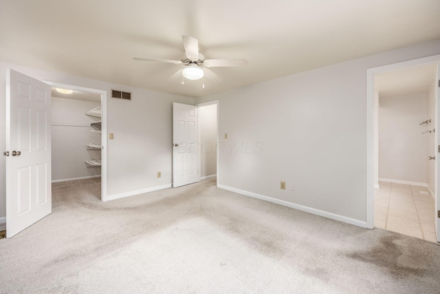 1609 Slade Ave, Columbus, OH 43235 - unfurnished bedroom featuring carpet, a spacious closet, baseboards, ceiling fan, and a closet