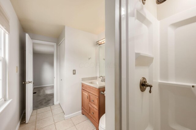 1609 Slade Ave, Columbus, OH 43235 - bathroom featuring vanity, tile patterned floors, toilet, baseboards, and a shower