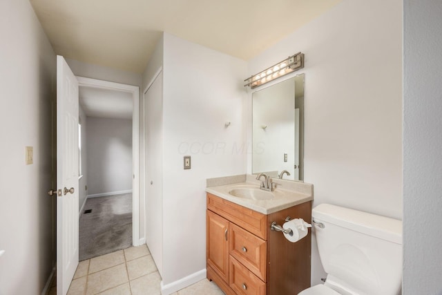 1609 Slade Ave, Columbus, OH 43235 - bathroom featuring vanity, toilet, tile patterned flooring, and baseboards