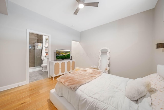 825 N 4th St Unit 406, Columbus, OH 43215 - bedroom with wood finished floors, baseboards, ensuite bathroom, and a ceiling fan