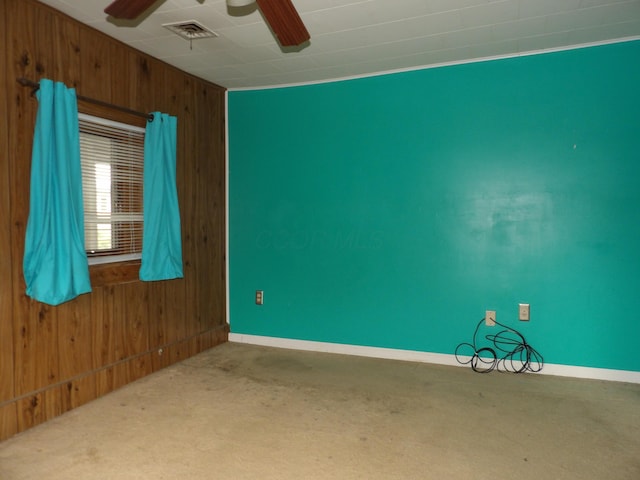 938 Meadowview Ave, Lancaster, OH 43130 - empty room with wooden walls, carpet, baseboards, and ceiling fan