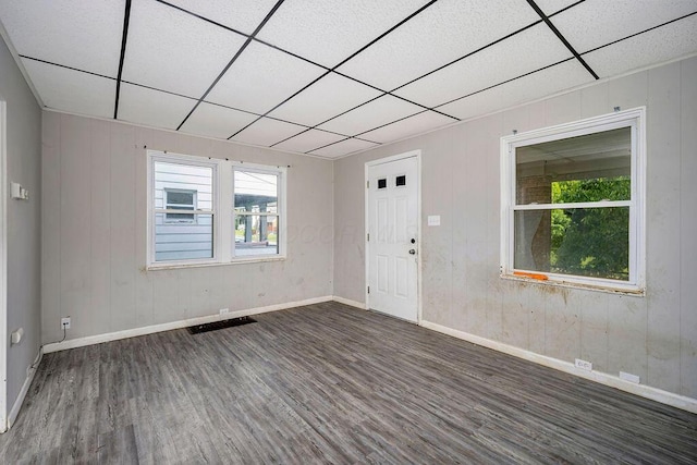 3102 Lehman Rd, Cincinnati, OH 45204 - unfurnished room featuring dark wood-style floors, plenty of natural light, baseboards, a paneled ceiling, and wood walls