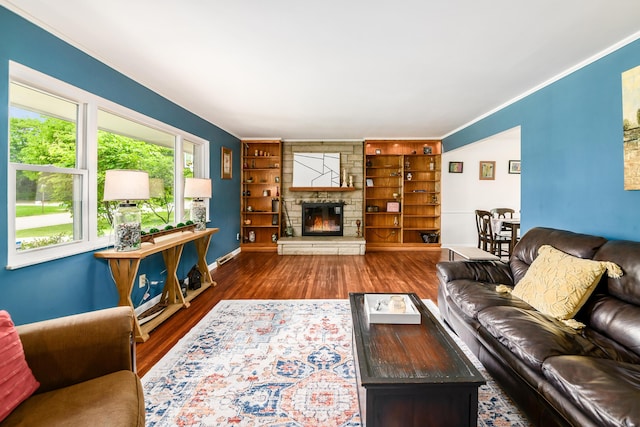 2175 Ridgeview Rd, Upper Arlington, OH 43221 - living area featuring wood finished floors, a fireplace, crown molding, built in shelves, and baseboards