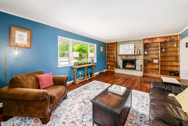 2175 Ridgeview Rd, Upper Arlington, OH 43221 - living area featuring baseboards, wood finished floors, built in shelves, a stone fireplace, and crown molding